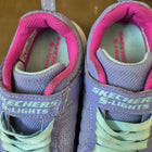 Purple and pink Skechers shoes with green laces 