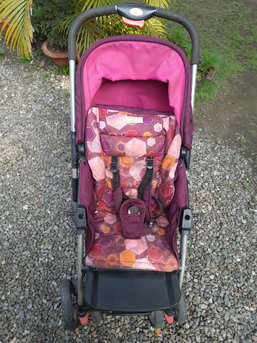 Stylish and lightweight pink baby stroller/pram with reclining seat, sun canopy, and smooth wheels for comfortable outings.