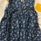 Blue dress with star and shell pattern on a yellow and white background