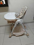 Baby high chair with tray on a tiled floor