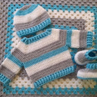 Sweater, Belt, Booties, and Blanket Set for Baby: Cozy and stylish winter ensemble, perfect for keeping your baby warm and fashionable.
