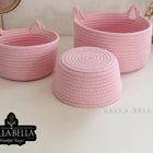 Three pink woven baskets 