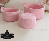 Three pink woven baskets 