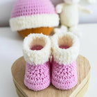 Handmade baby booties and beanie set, customizable with premium yarn for warmth, comfort, and a personal touch.