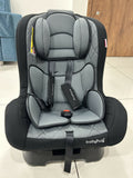 Gray and black baby car seat with 'babyhug' branding on a tiled floor.