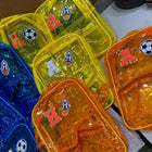Colorful transparent bags with letter and symbol decorations on a white surface