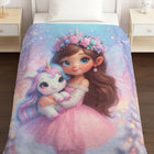 Blanket set with an illustration of a girl holding a unicorn on a bed.