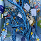 Blue rope with carabiners on a colorful fabric background