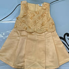Beige dress with floral embroidery on a blue background