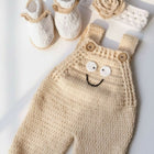 Knitted baby outfit with overalls, shoes, and headband 