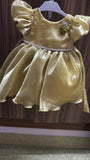 Yellow dress on a hanger against a wooden panel background