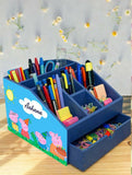 Blue children's desk organizer with stationery items 