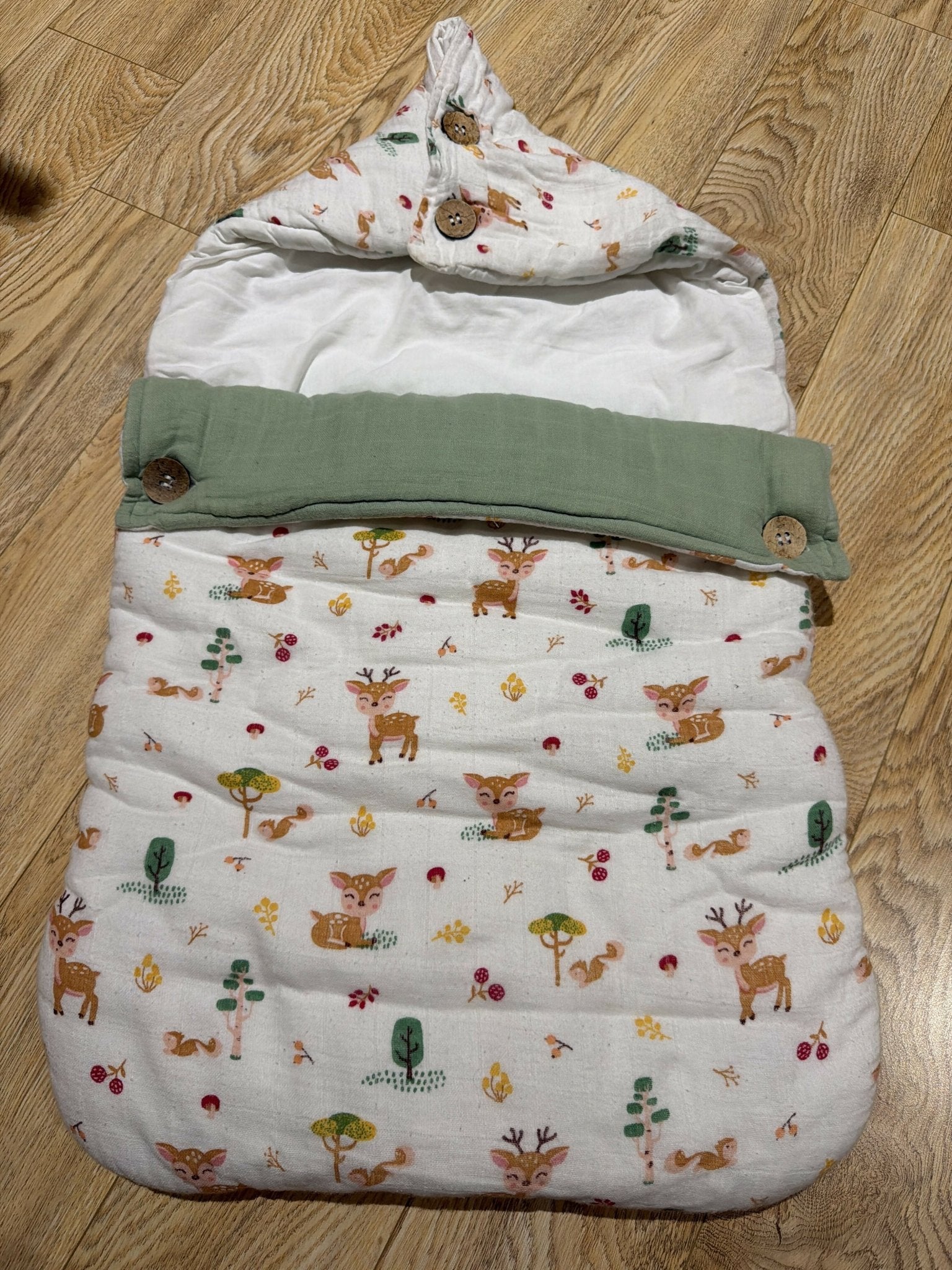 Haus & Kinder 3-in-1 Baby Sleeping Bag & Carry Nest in Whimsical Woodland with soft cotton fabric, portable carry nest, cozy bedding, secure wrap design, and skin-friendly materials for newborns aged 0–6 months.