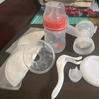 Collection of baby bottle parts on a dark surface
