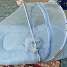 Blue baby crib with canopy on a patterned surface