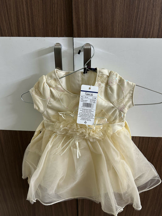 Gold dress on a hanger with a tag 