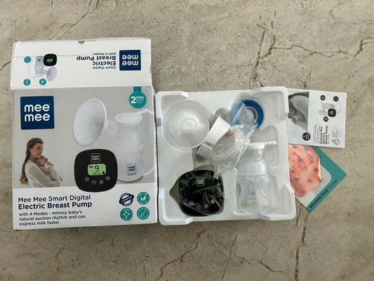 Mee Mee electric breast pump set with packaging on a concrete surface