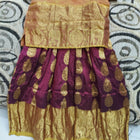 Traditional outfit with a gold blouse and maroon skirt 