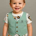 Child wearing a green vest 