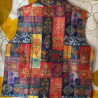Colorful patchwork vest on a white and yellow floral background
