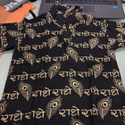 Black dress with gold patterns on a table