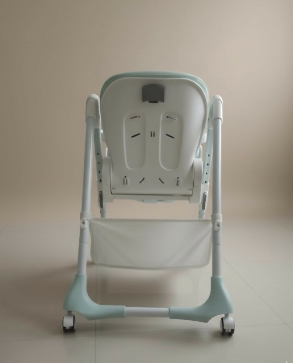 Baby high chair with a beige background