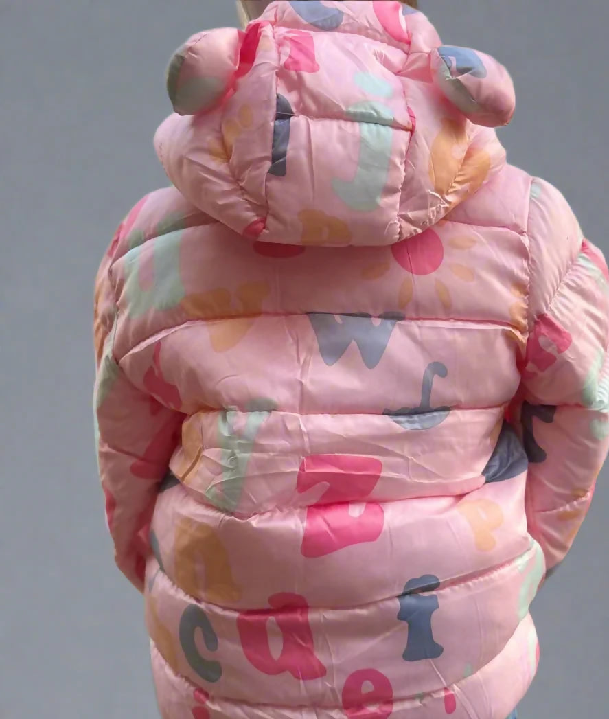 Child wearing a colorful pink puffer jacket with letter patterns 