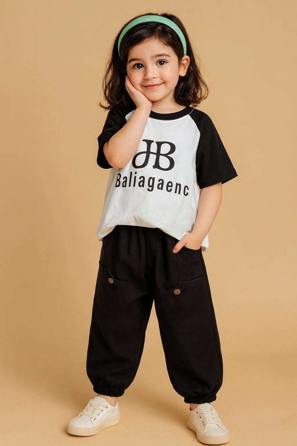 Child wearing a black and white shirt with text and black pants 