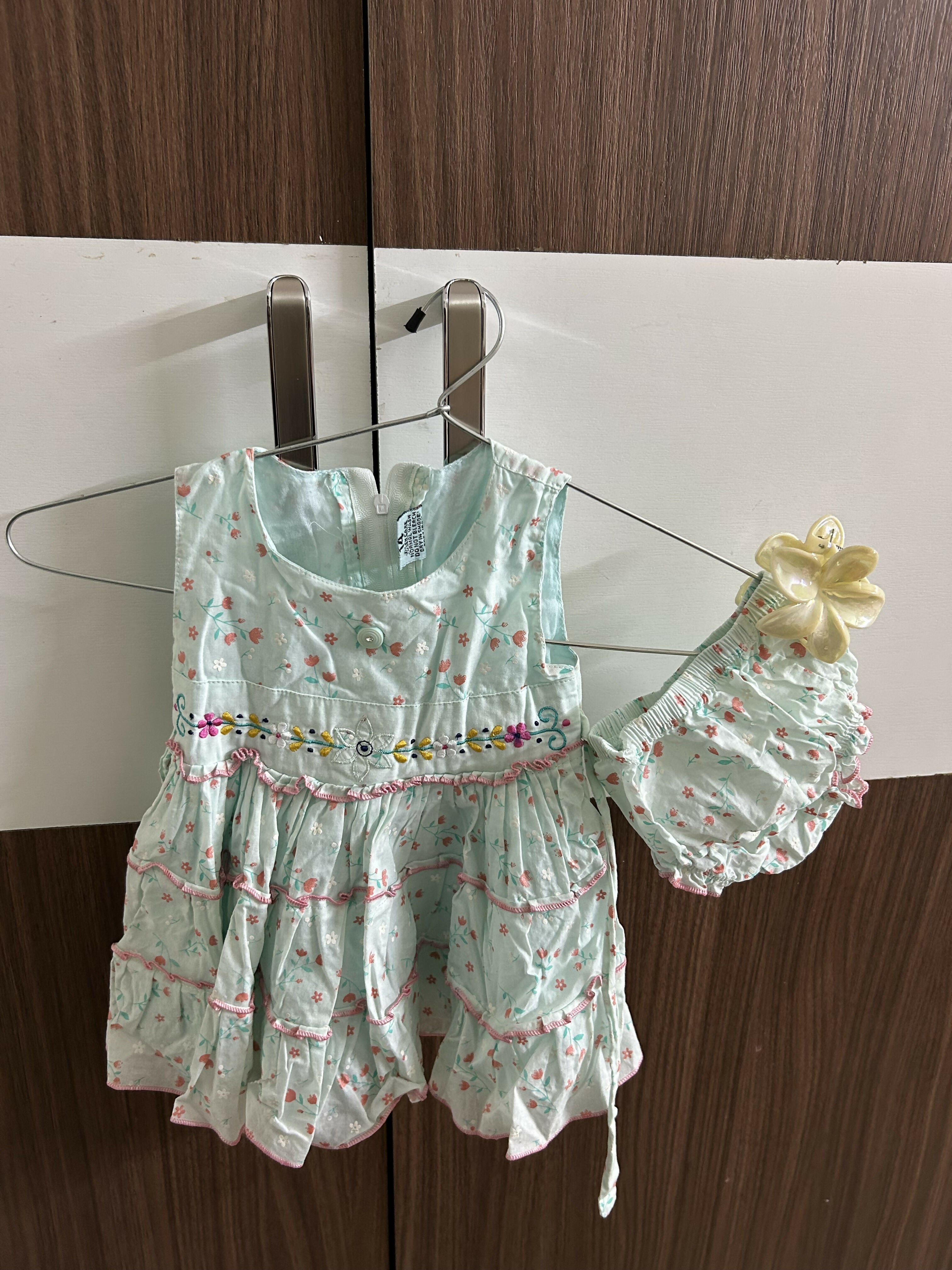 Light green children's dress with floral pattern 