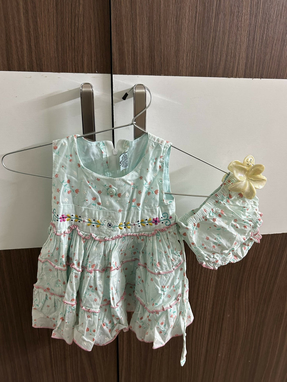 Light green children's dress with floral pattern 