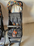 Black stroller with colorful patterned seat cover 