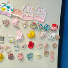 Collection of colorful baby hats and booties on a white surface with a blue background