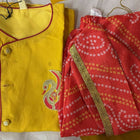 Yellow and red traditional outfit with a patterned fabric on a yellow background
