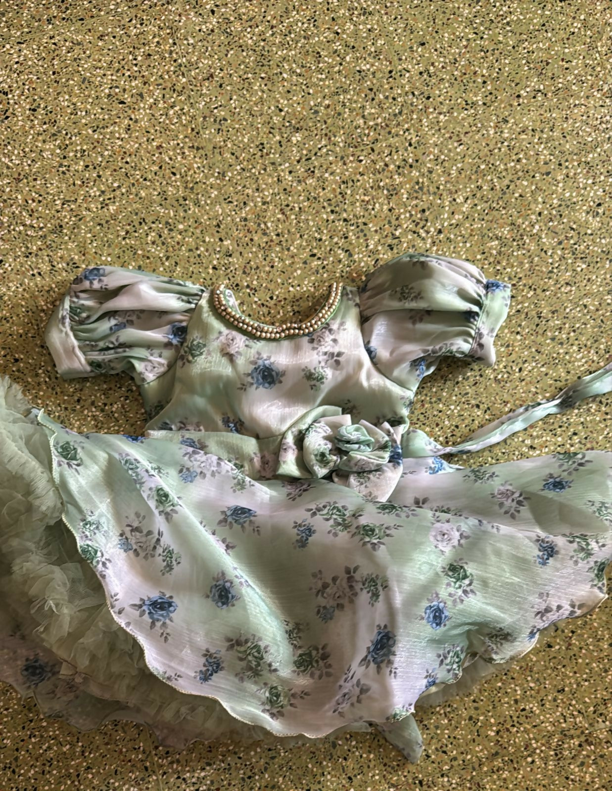 Floral dress with puff sleeves on a textured surface