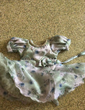 Floral dress with puff sleeves on a textured surface
