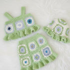 Green crochet baby outfit with floral patterns