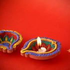 Embrace the spirit of creativity and tradition with our DIY Diya Kit, a delightful set designed to ignite your artistic flair while celebrating the warmth of Diwali. This kit includes five beautiful diyas and a palette of vibrant paint colors, allowing you to personalize and illuminate your festival of lights.