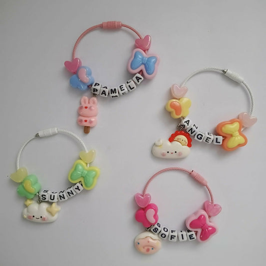 Set of colorful hair ties with cartoon characters and personalized names 