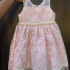 Adorn your baby girl in this elegant Pearl and Lace Work Frock, perfect for making precious memories!






