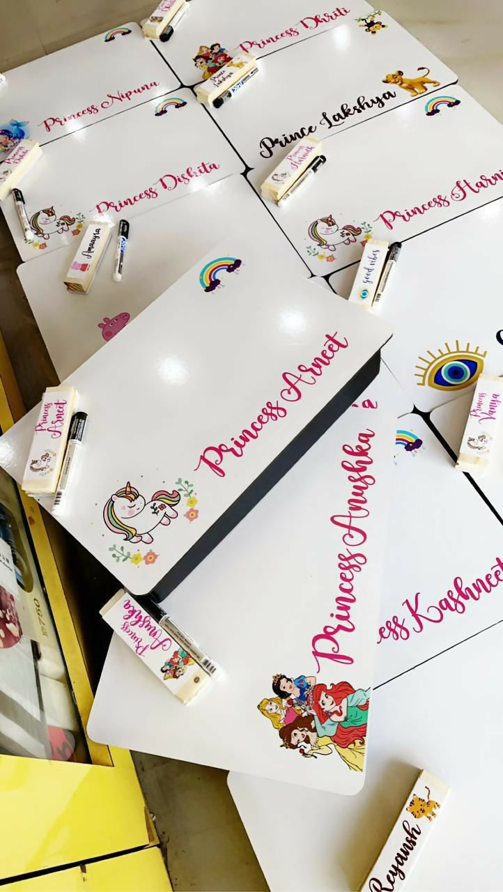 Collection of personalized name cards with cartoon designs on a white surface.