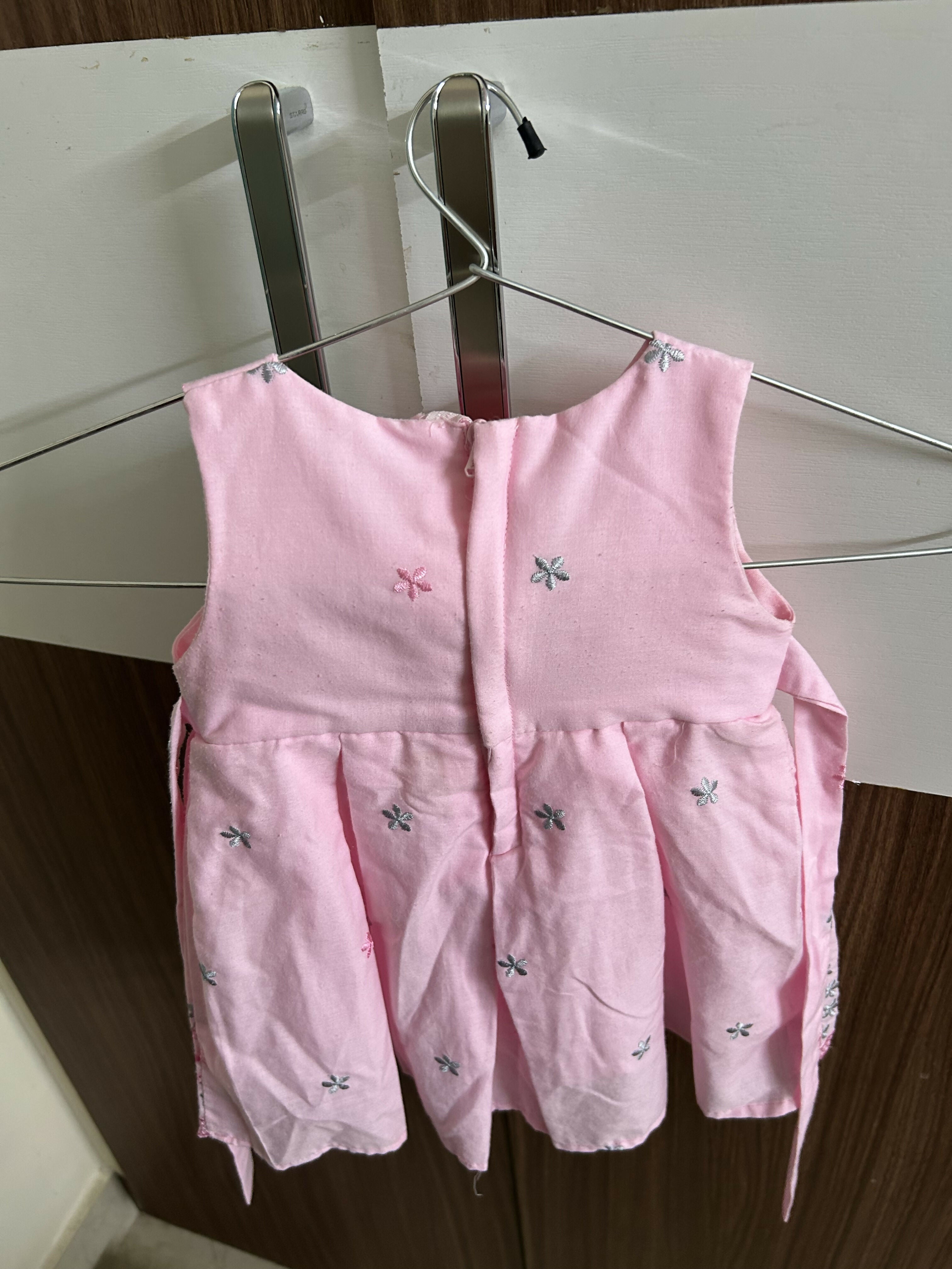 Pink children's dress with floral patterns