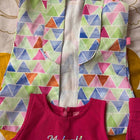 Colorful geometric-patterned jacket over a pink garment with 'My craft' text on a patterned background