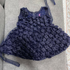 Navy blue floral dress with a matching headband on a gray surface