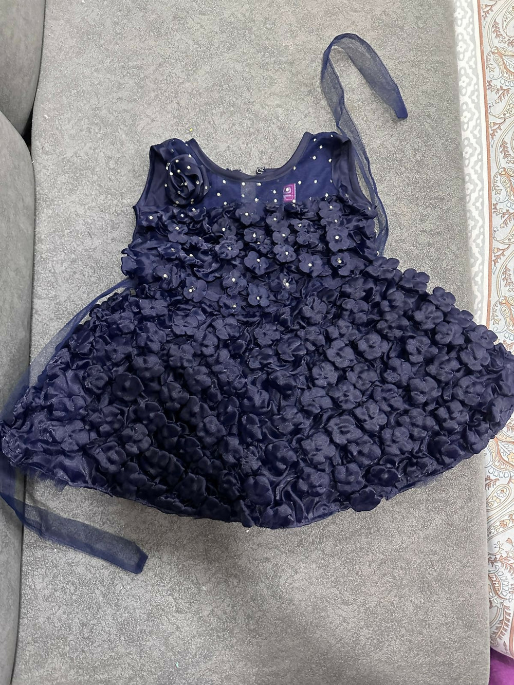 Navy blue floral dress with a matching headband on a gray surface