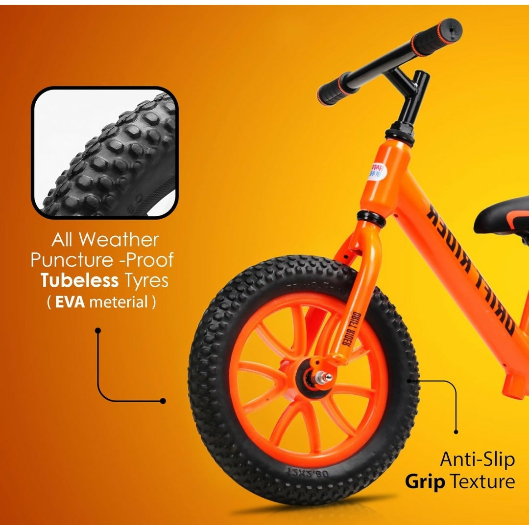 Orange balance bike with black tires on an orange background
