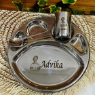 Personalized stainless steel kids thali set with 5 compartments, engraved name ‘Advika’, including spoon, fork, and glass with princess design.