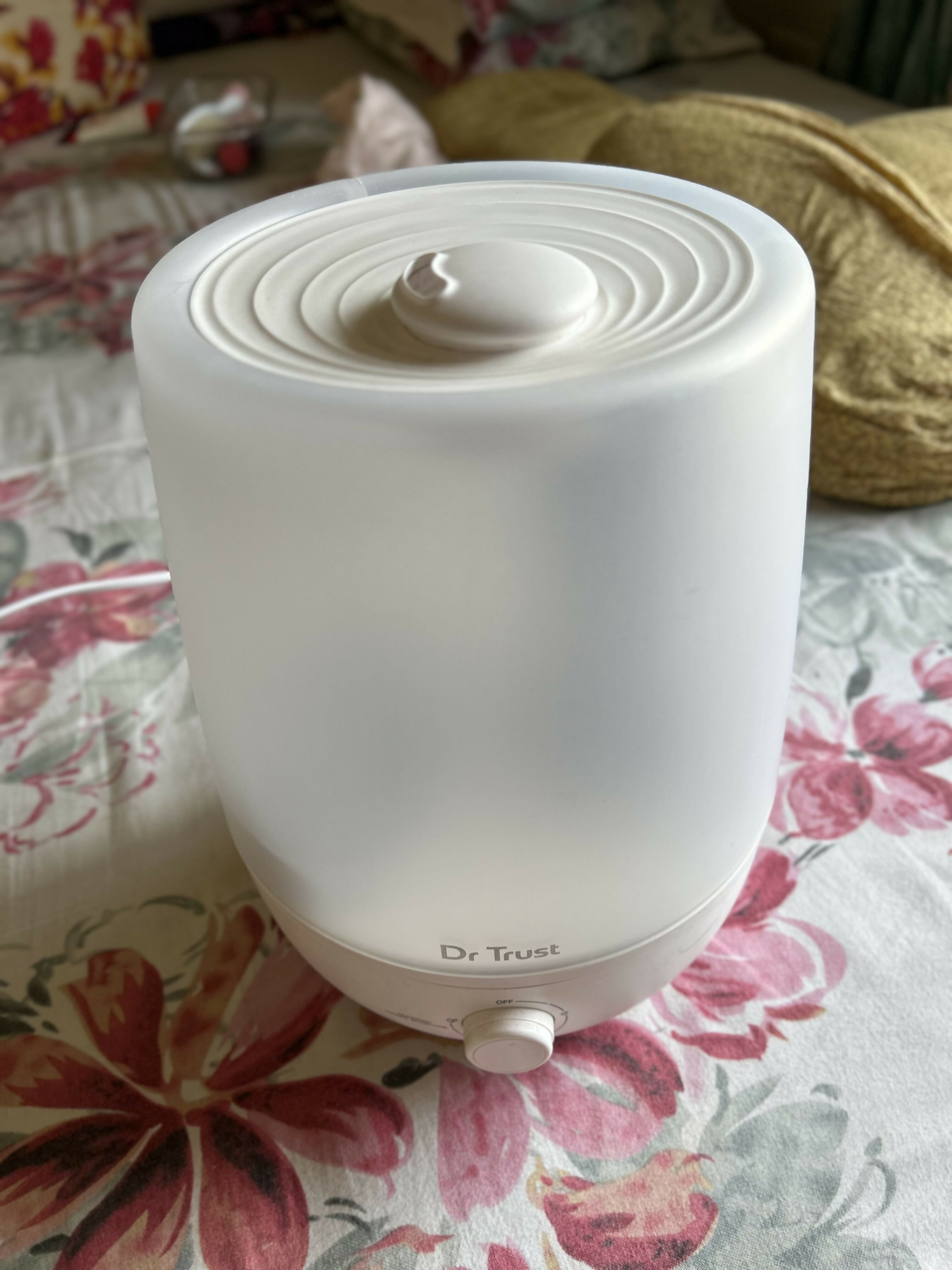 White humidifier with 'Dr. Trust' branding on a floral-patterned surface