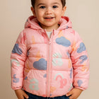 Child wearing a pink puffer jacket with cloud patterns 